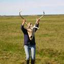 Amanda holding up a caribou head.